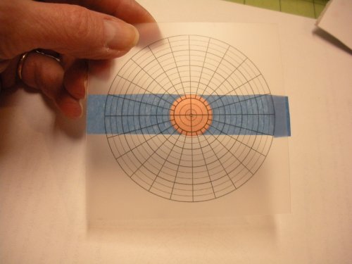 Judy Larson's How to Find and Mark the Center of a Disc. - How to Use, Wire Jewelry Design, Design, Tools, Hold the plastic in place over the disc.